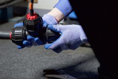 Gloved Hand Tightening Philmac Fitting onto Pipe with Retro-Line